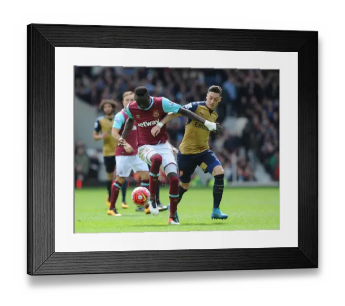 Framed Print : Intense Rivalry: Ozil vs. Kouyate Clash at the Boleyn Ground (2015-16)