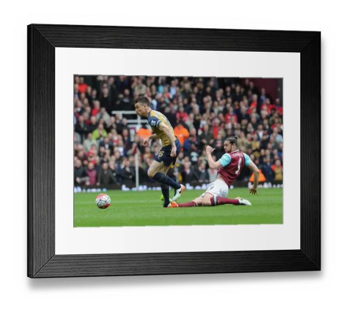 Framed Print : Arsenal's Koscielny Fouled by Carroll in Intense West Ham vs Arsenal Clash (2015-16) Framed Print : Arsenal's Koscielny Fouled by Carroll in Intense West Ham vs Arsenal Clash (2015-16)
