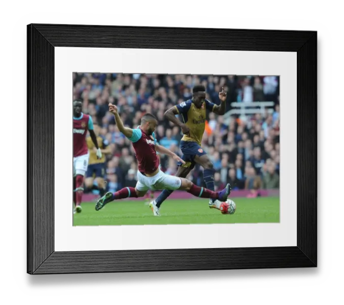 Framed Print : Intense Rivalry: Welbeck vs. Reid Clash in Arsenal's Battle at The Boleyn Ground