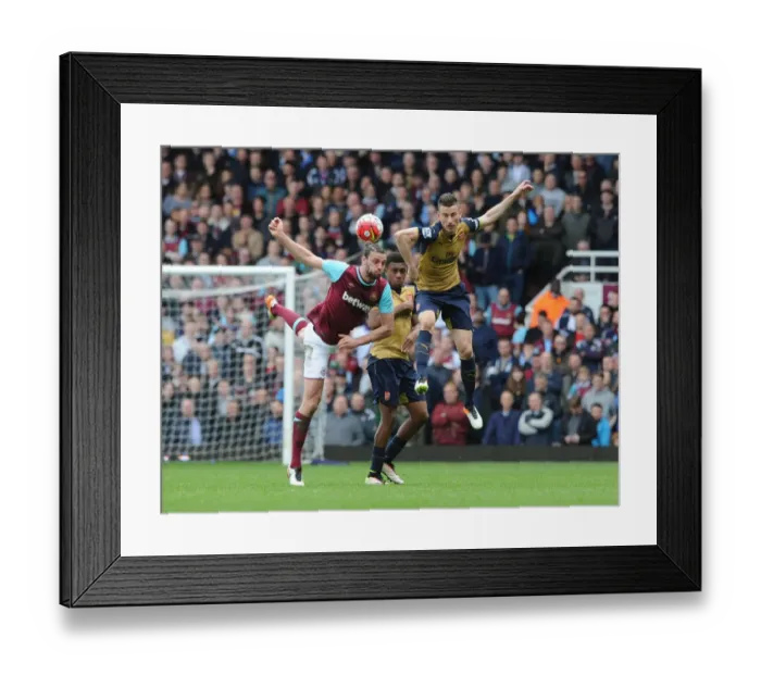 Framed Print : Clash at The Boleyn Ground: Koscielny and Iwobi vs. Carroll - Arsenal vs. West Ham United, Premier League 2015-16 Framed Print : Clash at The Boleyn Ground: Koscielny and Iwobi vs. Carroll - Arsenal vs. West Ham United, Premier League 2015-16