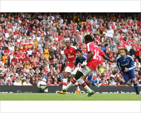 Emmanuel Adebayor shoots past Jerzy Dudek to score
