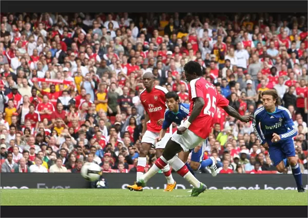 Emmanuel Adebayor shoots past Jerzy Dudek to score