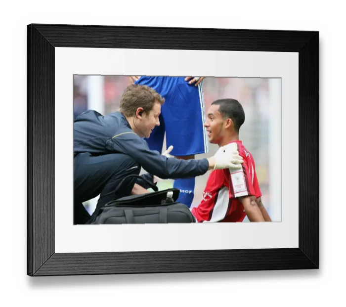 Framed Print : Theo Walcott's Victory Over Real Madrid: Arsenal's 1-0 Emirates Cup Triumph with Physio Colin Lewin Framed Print : Theo Walcott's Victory Over Real Madrid: Arsenal's 1-0 Emirates Cup Triumph with Physio Colin Lewin