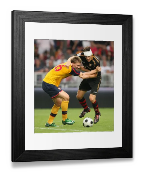 Framed Print : Nicklas Bendtner (Arsenal) Sebastien Squillaci (Seville) Framed Print : Nicklas Bendtner (Arsenal) Sebastien Squillaci (Seville)
