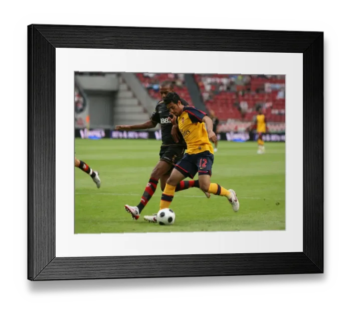 Framed Print : Carlos Vela beats Seville defender Abdoulay Konko to Framed Print : Carlos Vela beats Seville defender Abdoulay Konko to
