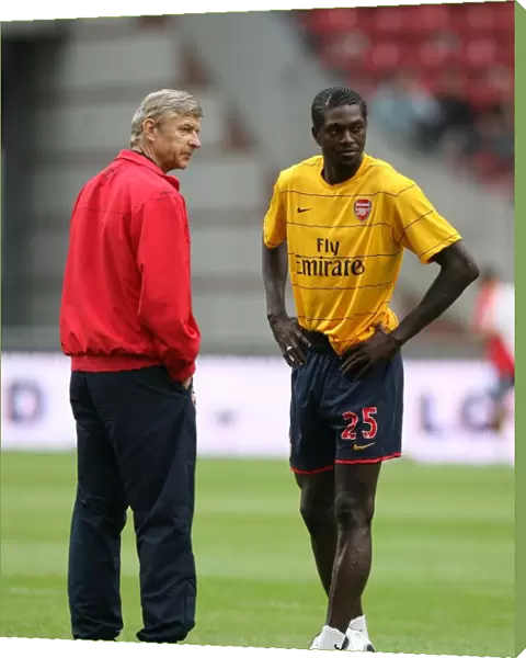 Arsenal manager Arsene Wenger with Emmanuel Adebayor