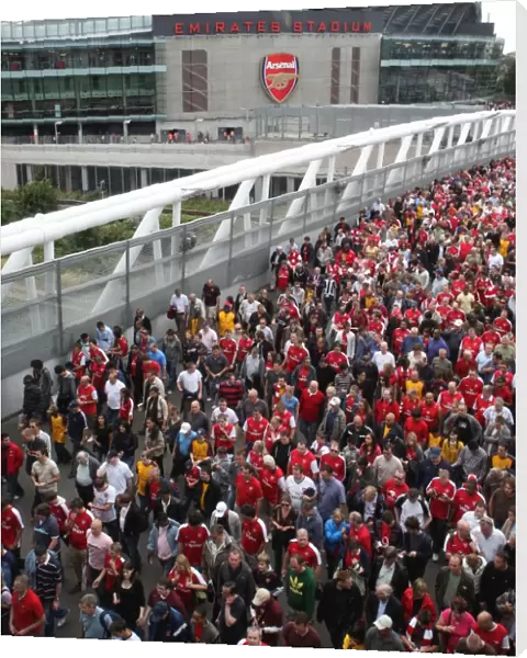 Arsenal fans make their way home after the match crossing