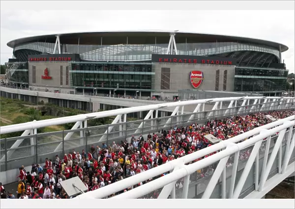 Arsenal fans cross the North Bridge after leaving the stadium