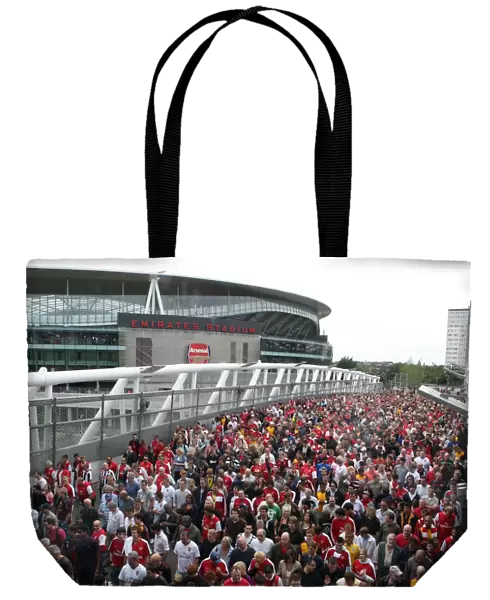Arsenal fans leave the stadium, crossing the North Bridge