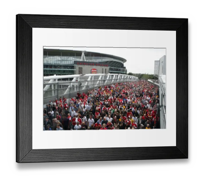 Framed Print : Arsenal fans leave the stadium, crossing the North Bridge