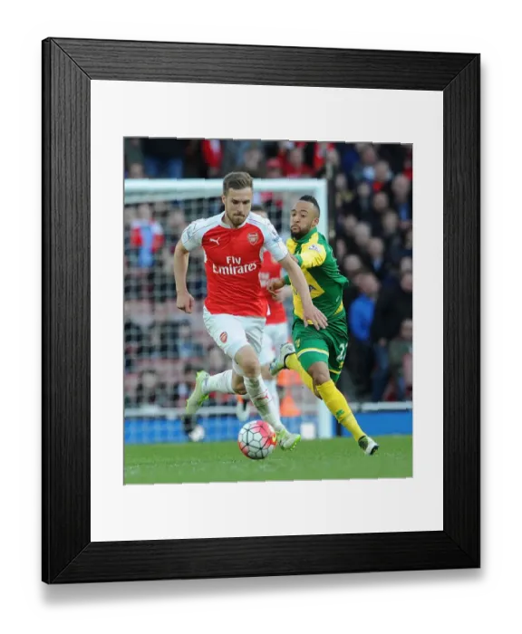 Framed Print : Ramsey vs. Redmond: Intense Face-Off Between Arsenal's Aaron Ramsey and Norwich's Nathan Redmond in Premier League Clash
