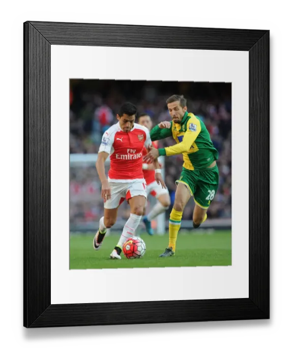 Framed Print : Arsenal's Alexis Sanchez vs. Norwich's Gary O'Neil: Intense Face-off during the 2015-16 Premier League Match