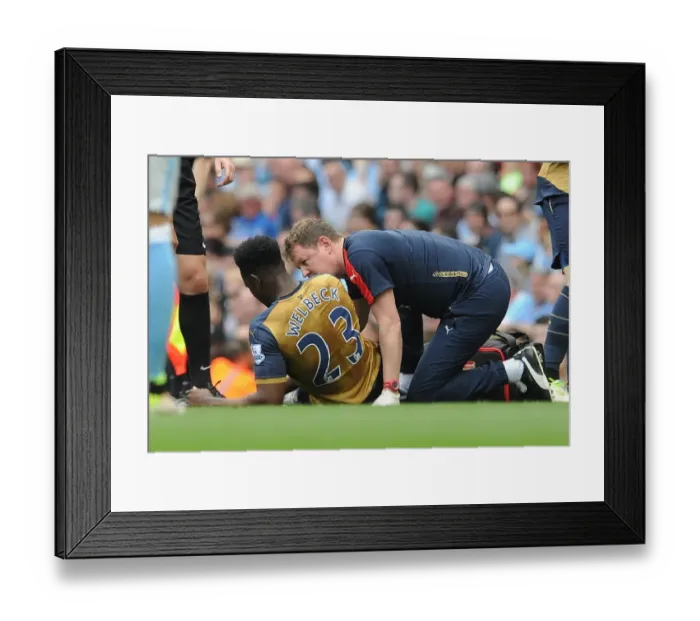 Framed Print : Danny Welbeck (Arsenal) is treated by Physio Colin Lewin. Manchester City 2: 2 Arsenal Framed Print : Danny Welbeck (Arsenal) is treated by Physio Colin Lewin. Manchester City 2: 2 Arsenal
