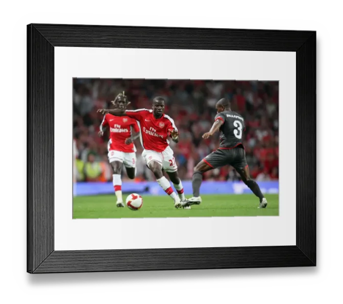 Framed Print : Arsenal's Double Victory Over Twente: Eboue Shines in 4-0 UEFA Champions League Win