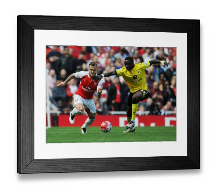 Framed Print : Arsenal's Jack Wilshere vs. Aly Cissokho: A Premier League Battle at Emirates Stadium