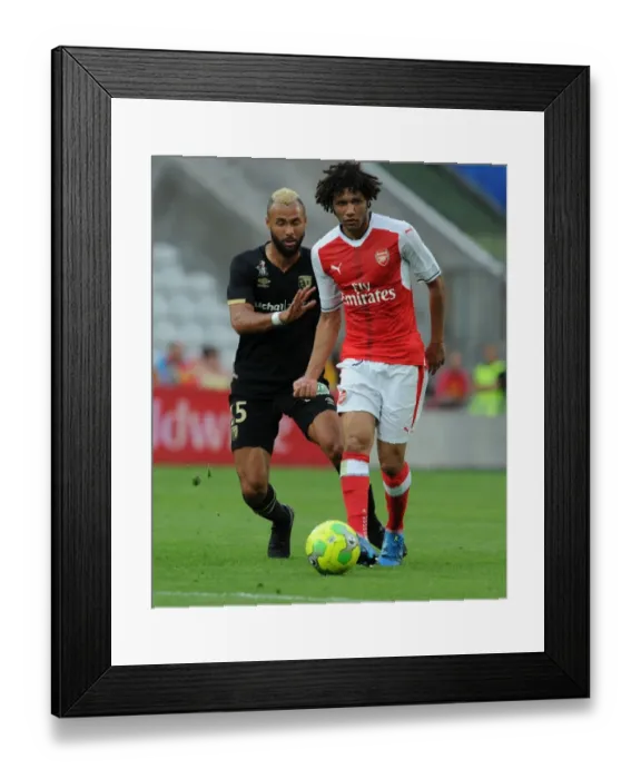Framed Print : Arsenal's Mohamed Elneny Overpowers Lens John Bostock in Pre-Season Clash Framed Print : Arsenal's Mohamed Elneny Overpowers Lens John Bostock in Pre-Season Clash