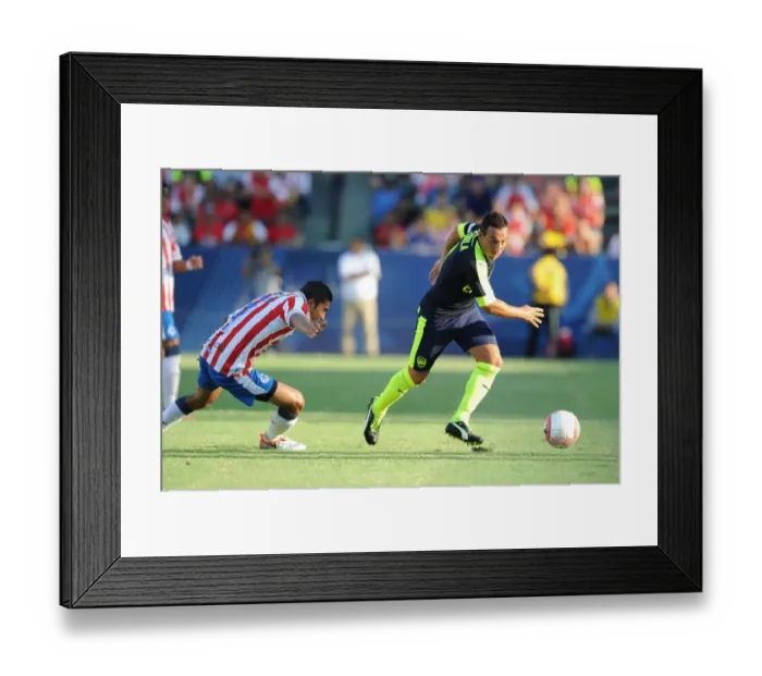 Framed Print : Arsenal's Santi Cazorla Outsmarts Orbelin Pineda in Pre-Season Showdown