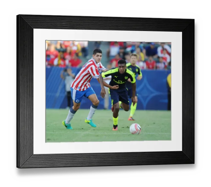 Framed Print : Arsenal's Alex Iwobi Breaks Past Chivas Orbelin Pineda in Pre-Season Clash Framed Print : Arsenal's Alex Iwobi Breaks Past Chivas Orbelin Pineda in Pre-Season Clash