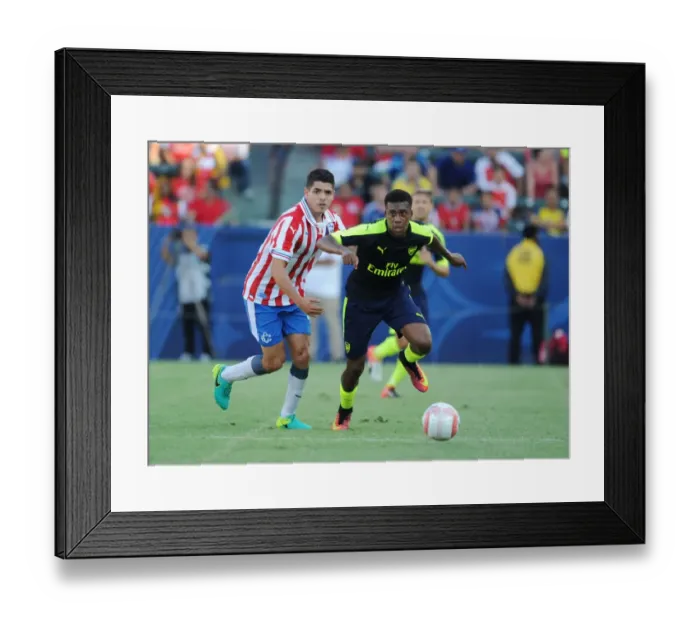 Framed Print : Alex Iwobi Outsmarts Orbelin Pineda: Arsenal Star's Agile Move in Pre-Season Clash Against Chivas Framed Print : Alex Iwobi Outsmarts Orbelin Pineda: Arsenal Star's Agile Move in Pre-Season Clash Against Chivas