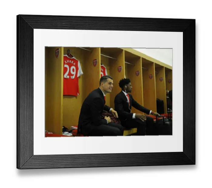 Framed Print : Arsenal Squad Unity: A Moment of Camaraderie - Xhaka and Akpom in the Changing Room before Arsenal vs Liverpool (2016-17)