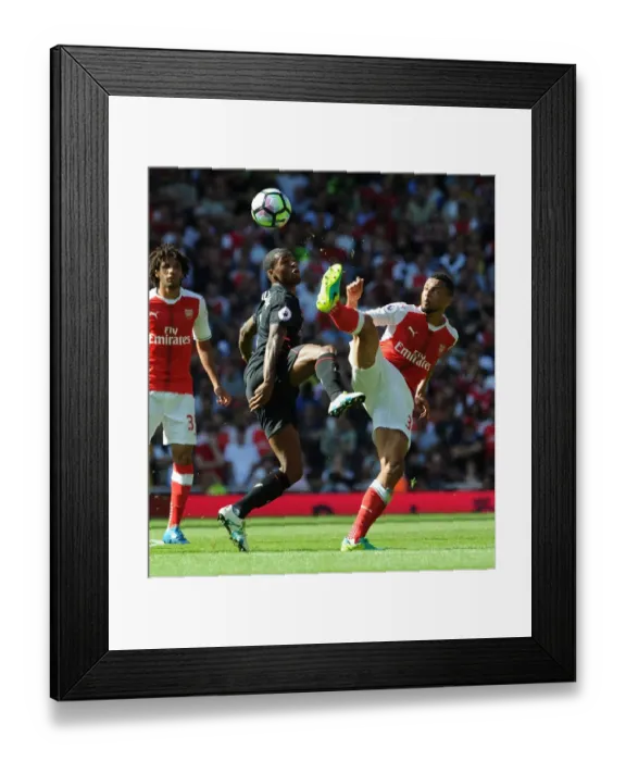 Framed Print : Coquelin vs. Wijnaldum: A Premier League Battle at Emirates Stadium (2016-17) Framed Print : Coquelin vs. Wijnaldum: A Premier League Battle at Emirates Stadium (2016-17)