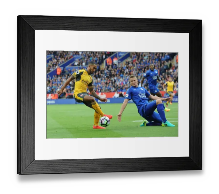 Framed Print : Theo Walcott vs. Robert Huth: A Premier League Battle at The King Power Stadium Framed Print : Theo Walcott vs. Robert Huth: A Premier League Battle at The King Power Stadium