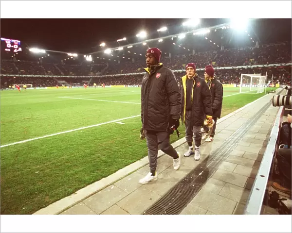 Johan Djourou, Arturo Lupoli and Cesc Fabregas (Arsenal) make their way to the substitutes bench aft