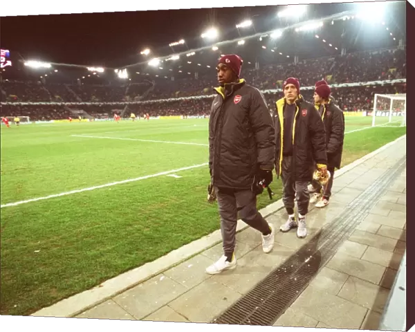 Johan Djourou, Arturo Lupoli and Cesc Fabregas (Arsenal) make their way to the substitutes bench aft