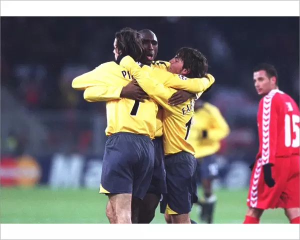 Robert Pires celebrates scoring a goal for Arsenal with Sol Campbell and Cesc Fabregas