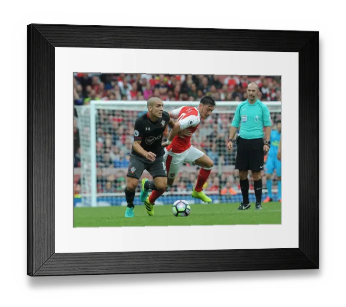 Framed Print : Mesut Ozil Faces Intense Pressure from Southampton's Oriol Romeu in Arsenal vs Southampton Clash (2016-17)