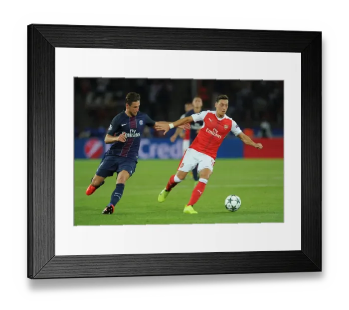 Framed Print : Mesut Ozil vs. Grzegorz Krychowiak: A Champions League Battle at Parc des Princes, 2016