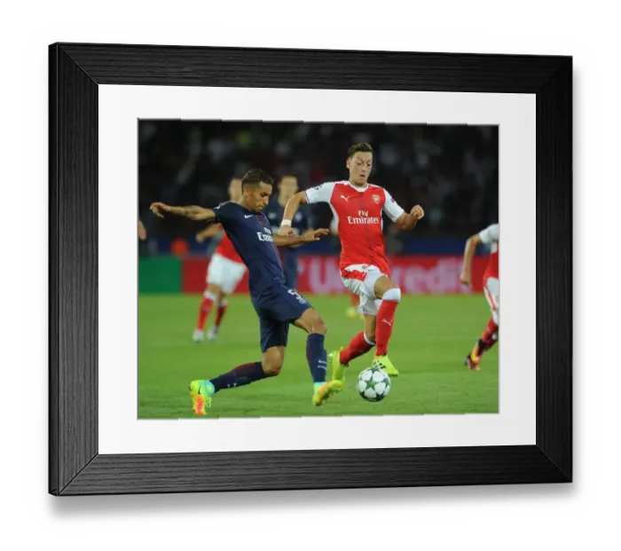 Framed Print : Mesut Ozil vs. Marquinhos: A Clash in the UEFA Champions League between Paris Saint-Germain and Arsenal