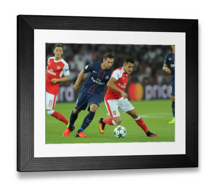 Framed Print : Champions League Showdown: Sanchez vs. Krychowiak - Paris Saint-Germain vs. Arsenal: A Battle of Stars at Parc des Princes