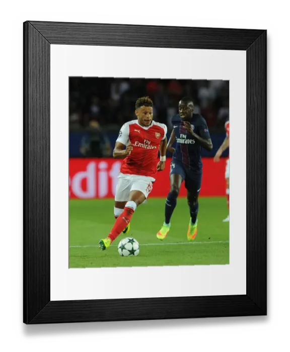 Framed Print : Champions League Showdown: Oxlade-Chamberlain's Determined Performance - Paris Saint-Germain vs. Arsenal