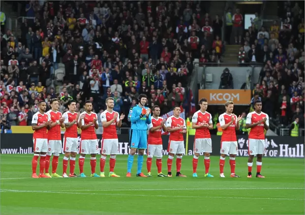 The Arsenal team take part in a minutes applause for a former Hull youth team player