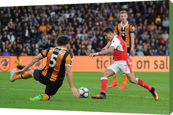 Alexis Sanchez scores his 2nd goal for Arsenal beating Harry McGuire (Hull) on the way