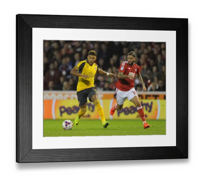 Framed Print : Alex Oxlade-Chamberlain vs. Henri Lansbury: A Battle in the EFL Cup Third Round between Nottingham Forest and Arsenal, 2016-17