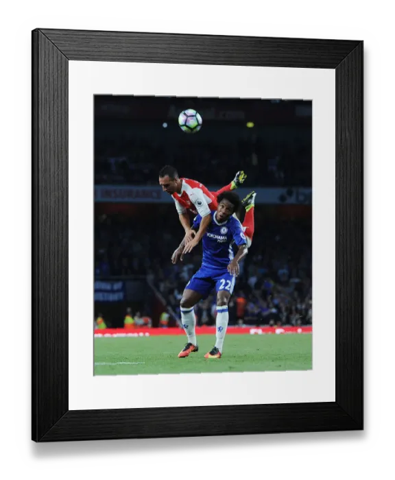 Framed Print : Arsenal's Santi Cazorla Soars Above Chelsea's Willian: Intense Moment from the Arsenal v Chelsea Clash (2016-17) Framed Print : Arsenal's Santi Cazorla Soars Above Chelsea's Willian: Intense Moment from the Arsenal v Chelsea Clash (2016-17)