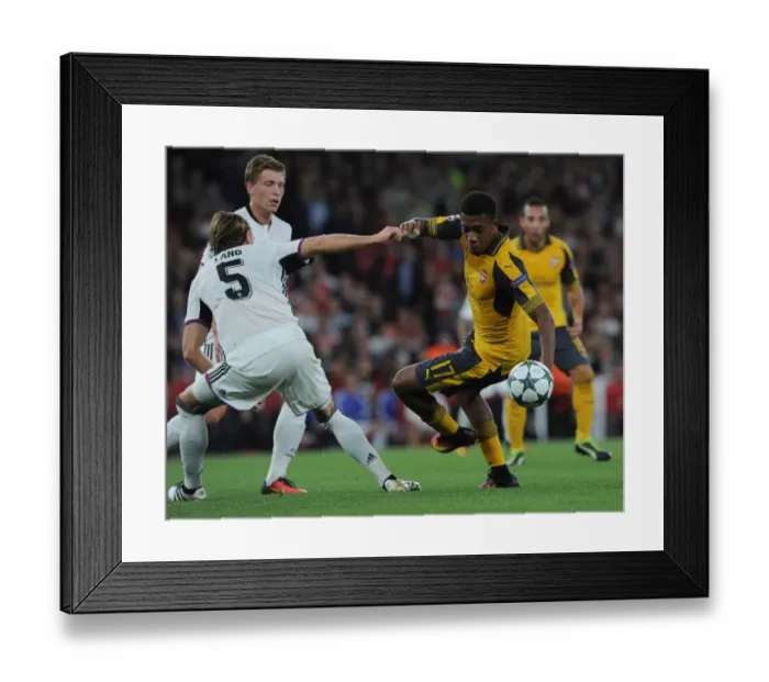 Framed Print : Arsenal's Alex Iwobi Battles Basel's Michael Lang in Champions League Showdown