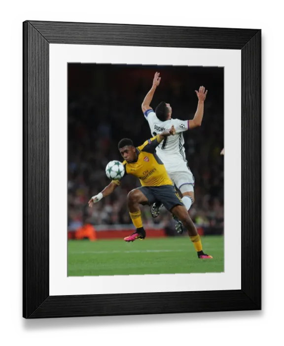 Framed Print : Arsenal's Alex Iwobi vs. FC Basel's Marek Suchy: A Champions League Showdown Framed Print : Arsenal's Alex Iwobi vs. FC Basel's Marek Suchy: A Champions League Showdown
