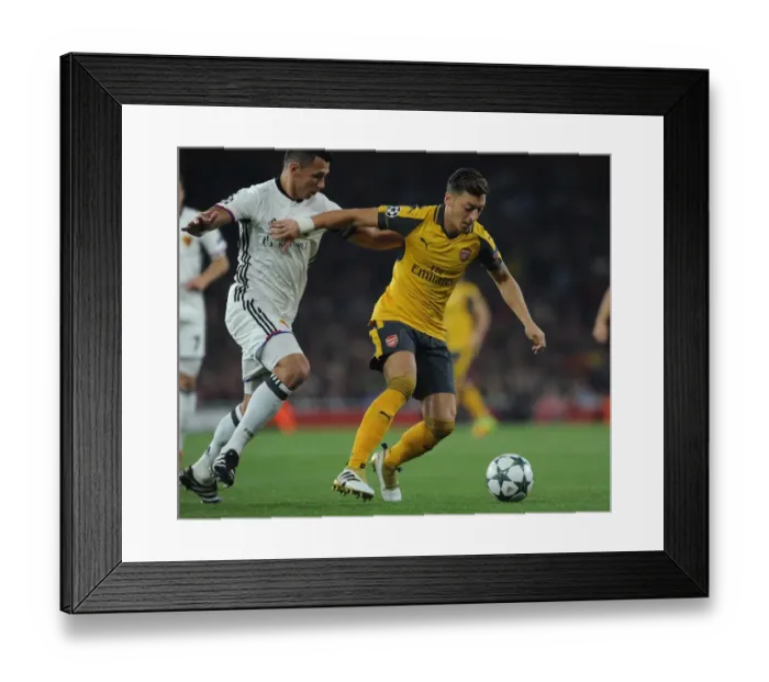 Framed Print : Mesut Ozil vs Marek Suchy: A Fierce Battle in Arsenal's Champions League Showdown