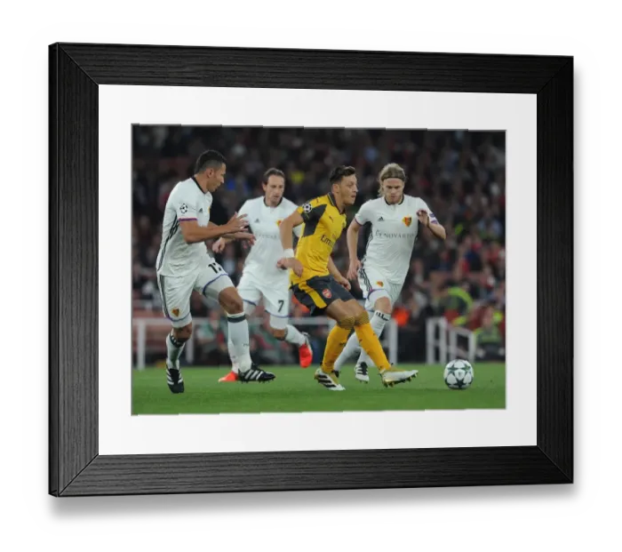 Framed Print : Mesut Ozil vs Marek Suchy: A Battle in Arsenal's UEFA Champions League Clash with FC Basel