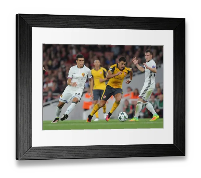 Framed Print : Clash of Stars: Alexis Sanchez vs. Mohamed Elyounoussi in Arsenal's UEFA Champions League Battle (2016-17)