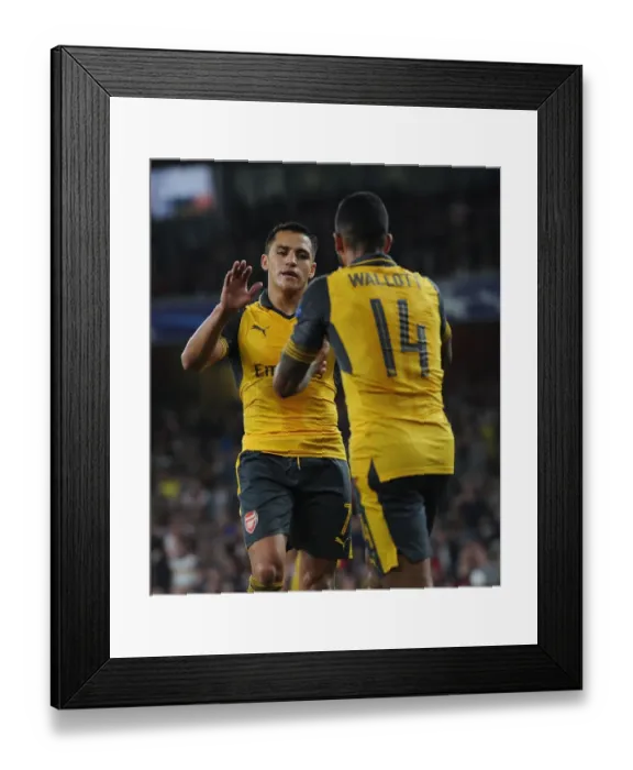 Framed Print : Arsenal Stars: Sanchez and Walcott's Unforgettable Moment of Celebration during Arsenal vs. FC Basel UEFA Champions League Match