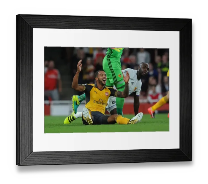Framed Print : Arsenal's Theo Walcott vs. Eder Balanta: A Penalty Dispute in the UEFA Champions League Clash between Arsenal and FC Basel