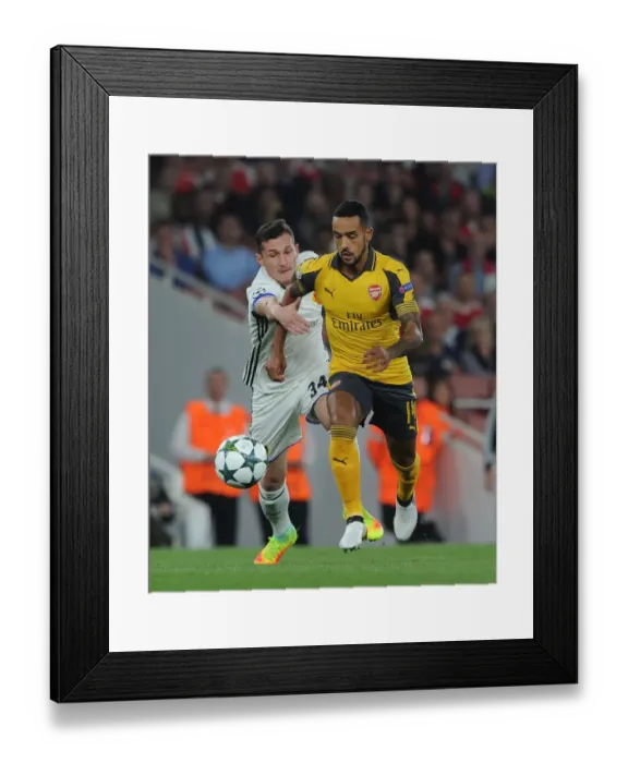 Framed Print : Theo Walcott vs. Taulant Xhaka: A Battle in the Arsenal FC vs. FC Basel UEFA Champions League Clash