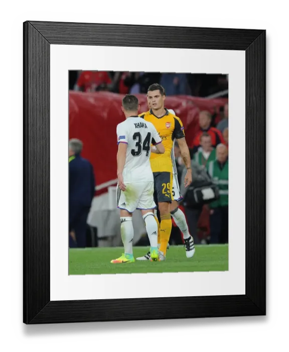 Framed Print : Brothers in Football: A Heartfelt Reunion - Granit and Taulant Xhaka at Arsenal vs. FC Basel