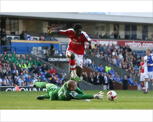 Emmanuel Adebayor shoots past Paul Robinson to score