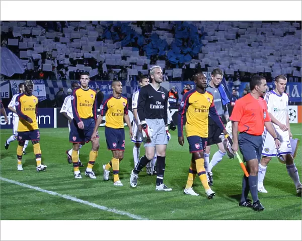 The Arsenal and Kiev teams walk onto the pitch before the match