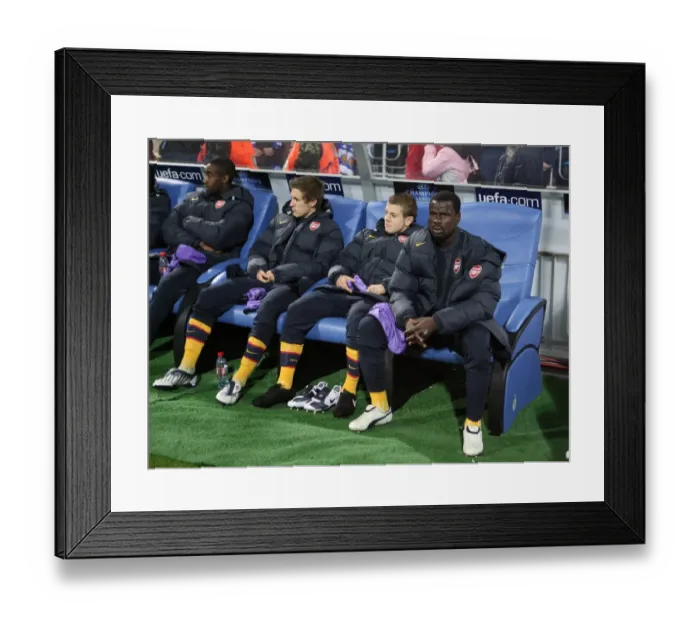 Framed Print : Emmanuel Eboue on the Arsenal bench before the match Framed Print : Emmanuel Eboue on the Arsenal bench before the match